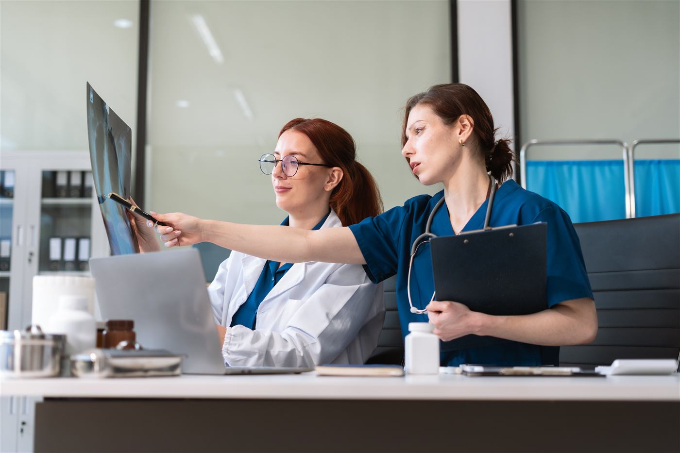 Two clinicians reviewing an X-ray together