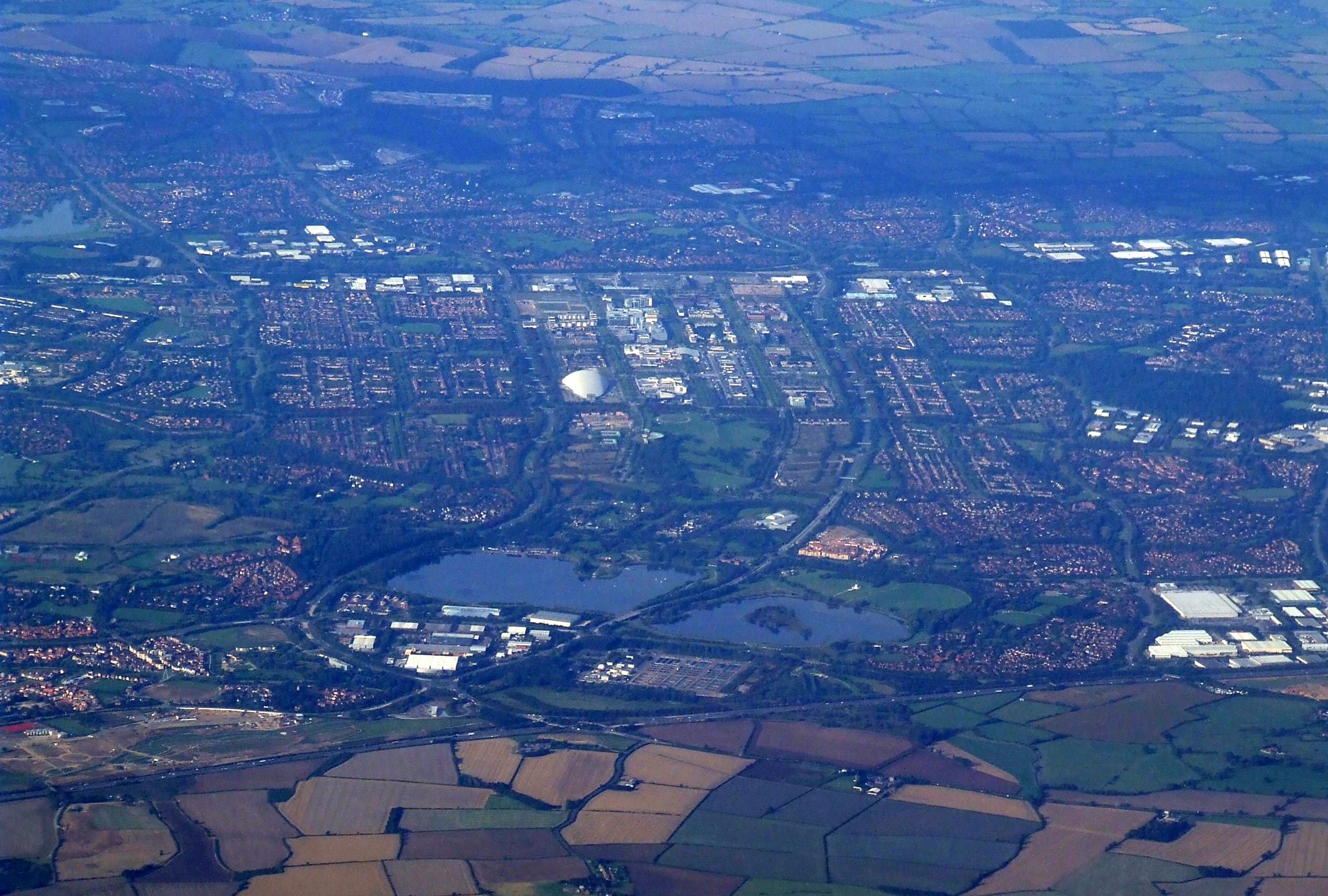Milton Keynes from the air, its grid of streets and parkland running out to the fields of north Buckinghamshire