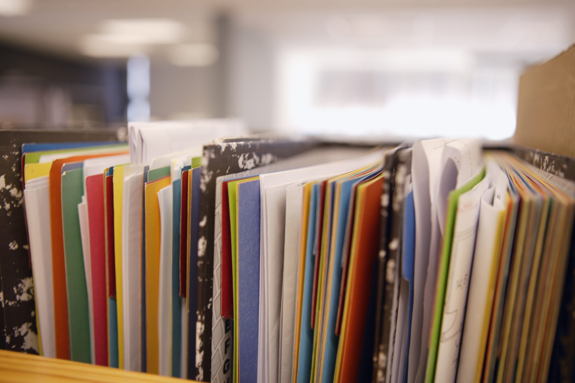 Well-used notebooks stacked on a desk