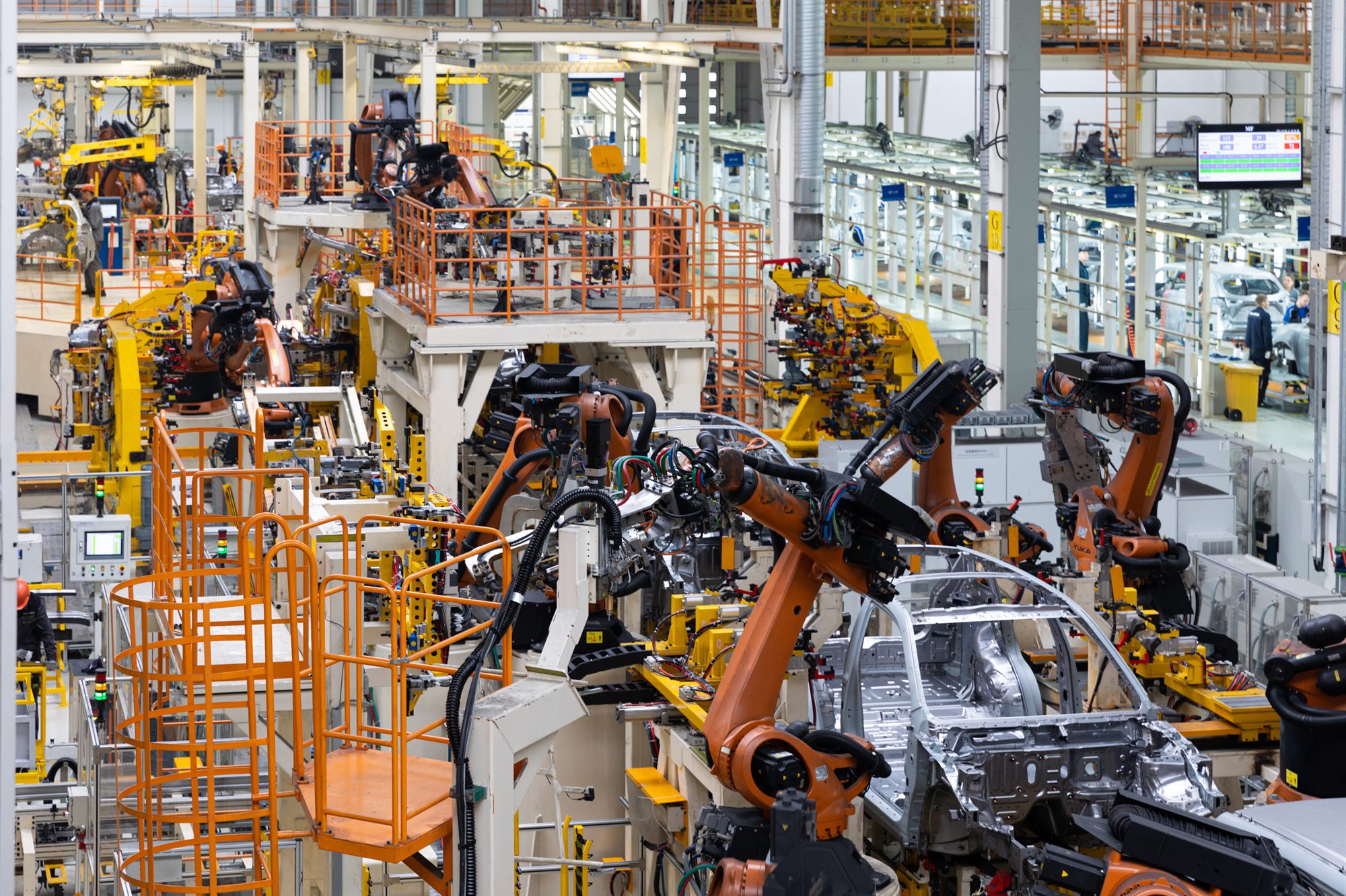 Car bodies moving along a factory assembly line