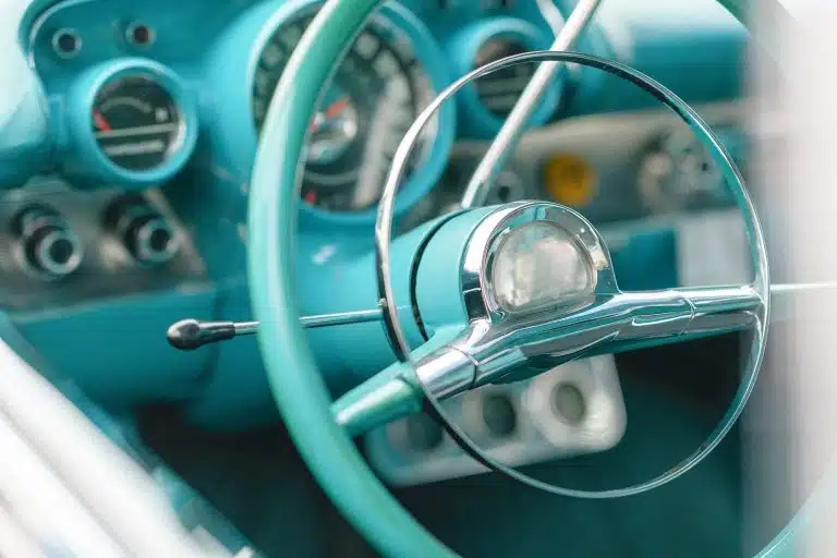 The steering wheel and dials of a vintage car