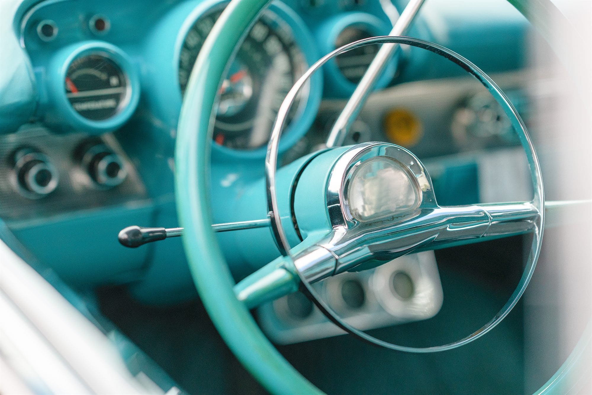 The steering wheel and dials of a vintage car
