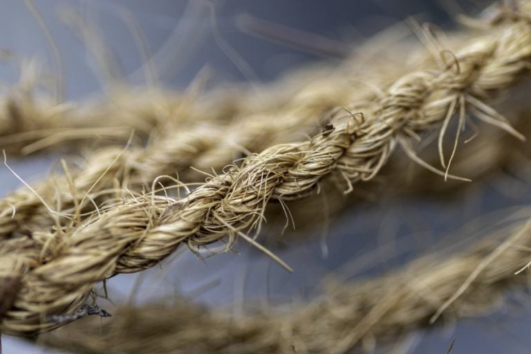 Close-up of a twisted natural fibre rope with frayed strands