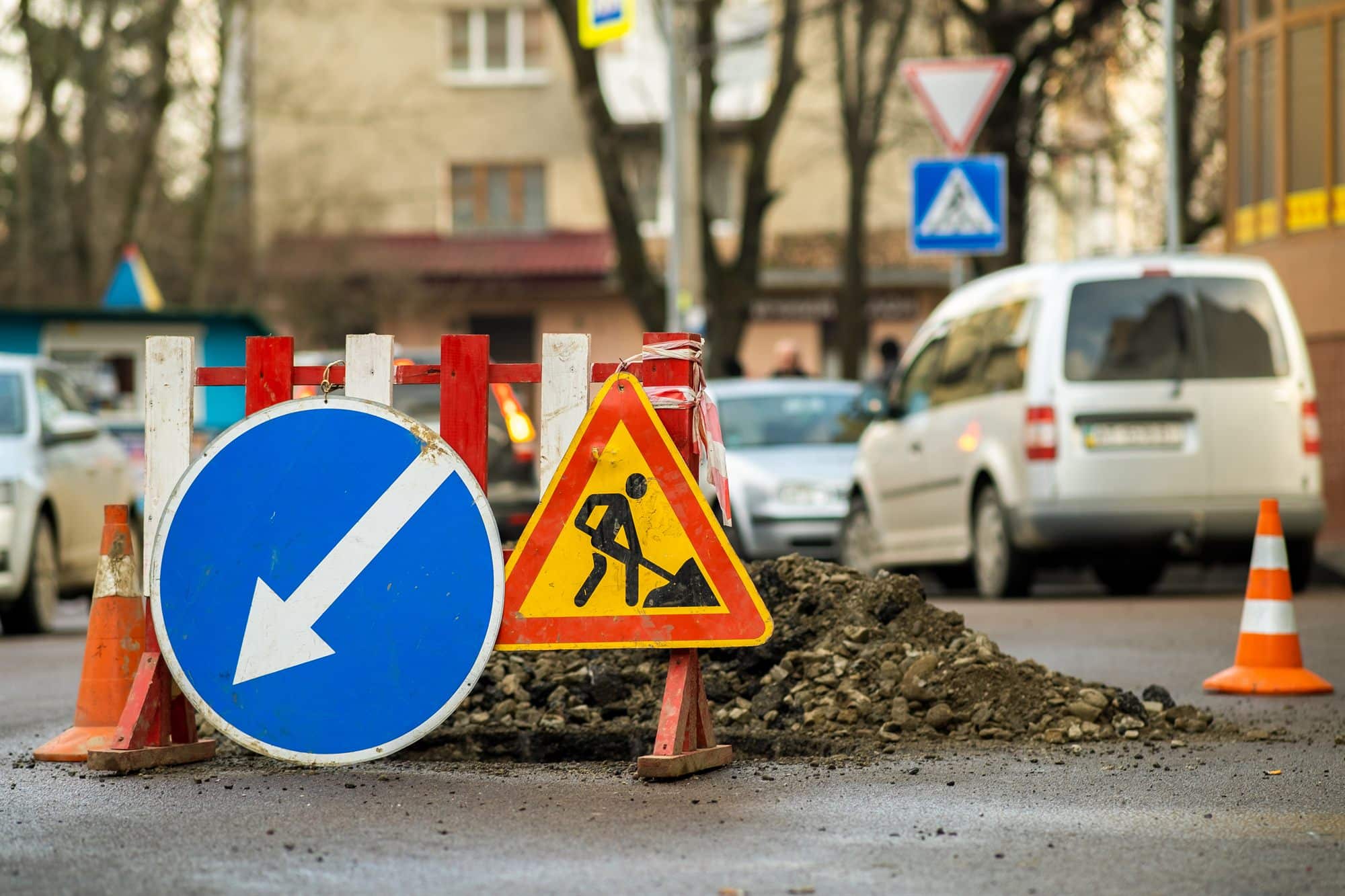 A warning sign standing at a road work site