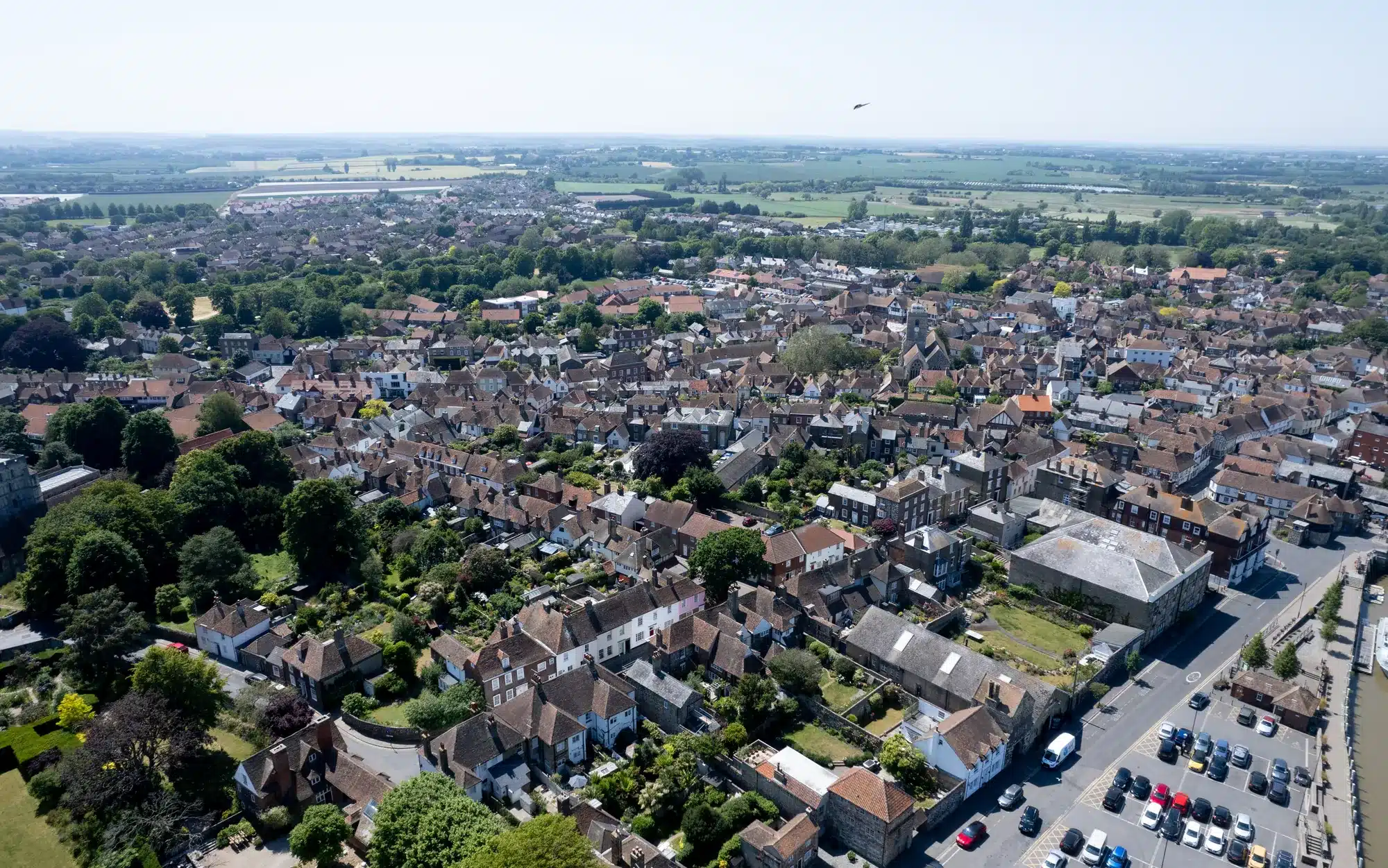 An English town seen from above, rooftops giving way to fields